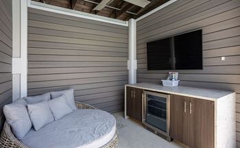 Sundeck with lounge chairs, tables, and chairs and four private cabanas each outfitted with daybed, minibar refrigerator and television